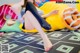 A woman sitting on a bean bag chair with a donut on it.