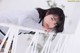 A young girl leaning on a white railing.