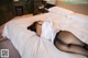 A woman laying on a bed in a hotel room.